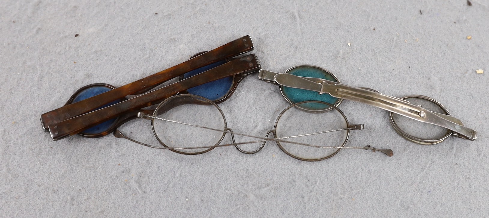 A pair of George IV silver mounted spectacles, with four lenses, (two folding and one missing), Joseph Wilmore, Birmingham, 1825? and tow other pairs of spectacles.